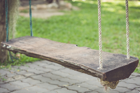 Close up old wooden swing in the gardenの写真素材