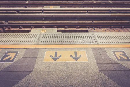 Close up Arrow sign on floor at the sky train station, bangkok, Thailandの写真素材