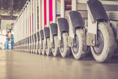 Close up trolleys luggage in a row in airport, retro filter effectの写真素材