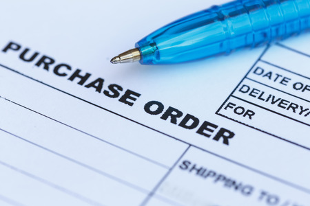 Close up purchase order with blue pen in the officeâの写真素材