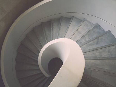 Inside design spiral staircase made of concreteの写真素材