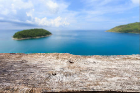 Close up old wood table top and view of oceanの写真素材