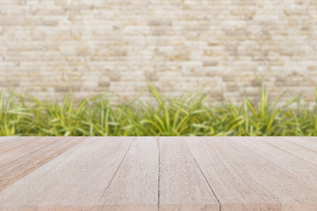 Close up top wooden table and blur of natural stone backgroundの写真素材