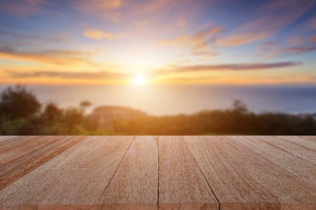 Close up top wooden table and blur sunset backgroundの写真素材