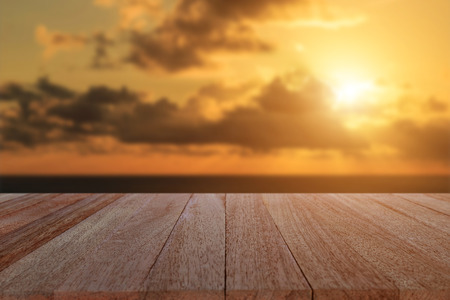 Close up top wooden table and blur sunset backgroundの写真素材