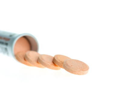 Orange lozenges for infections of the mouth and throat isolated on white backgroundの写真素材