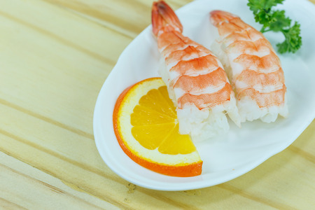 Traditional japanese food, Shrimp sushi or Ebi Nigiri on wooden backgroundの写真素材