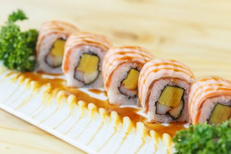Traditional japanese food, Salmon sushi roll maki on wooden tableの写真素材
