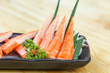 Traditional japanese food, Immitation Crab Sticks or Kani Kamaboko on wooden backgroundの写真素材