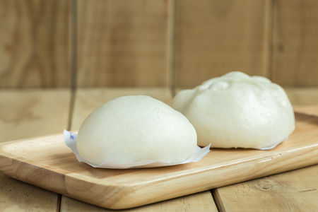 Close up white Steamed buns on wooden trayの写真素材