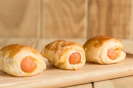Close up Danish Pastry with sausage on wooden dishの写真素材