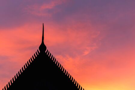 Silhouette Thai style temple roof and sunset backgroundの写真素材