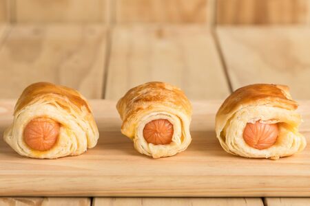 Close up Danish Pastry with sausage on wooden dishの写真素材