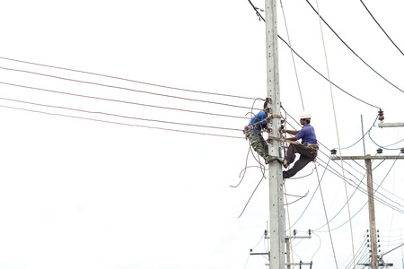 PHUKET, THAILAND - SEPTEMBER 17, 2015: The unidentified people is working on crane for install new traffic light on September 17, 2015 in Phuket, Thailand.のeditorial素材