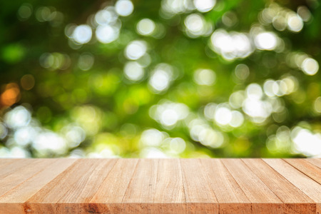 Empty top wooden table and sunny abstract blurred bokeh backgroundの写真素材