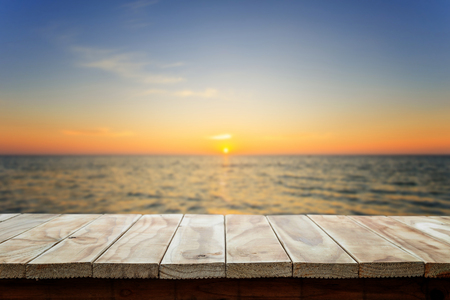 Empty top of wooden table or counter and view of tropical beach. For product displayの写真素材