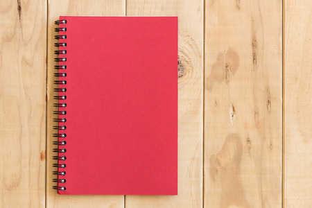 Top view of red book on wooden table backgroundの写真素材