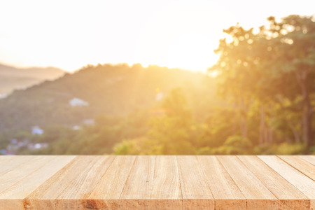 Empty top wooden table and sunny abstract blurred bokeh backgroundの写真素材