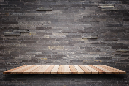 Empty top wooden shelves and stone wall background. For product displayの写真素材