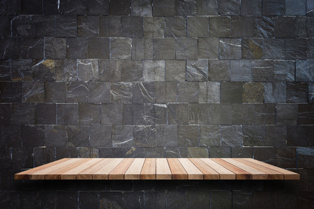 Empty top wooden shelves and stone wall background. For product displayの写真素材