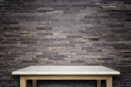 Empty top of natural stone table and stone wall background. For product displayの写真素材