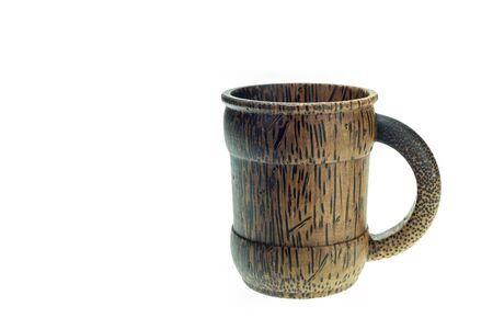 Close up brown wooden coffee cup made from palm wood isolated on white backgroundの写真素材