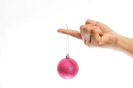 Close up hand holding Christmas ball isolated on white backgroundの写真素材
