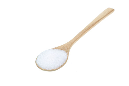 Close up of white sugar in wooden spoon isolated on white backgroundの写真素材