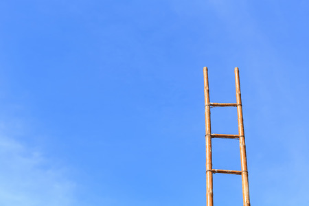 Long bamboo ladder and blue sky background