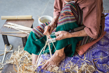 Thai woman working on bamboo using for umbrella in Thailandの写真素材
