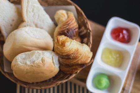 Top view of different bread with jam on wooden tableの写真素材
