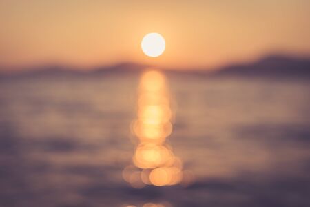 Abstract of sun light with bokeh and reflection on the waterの写真素材