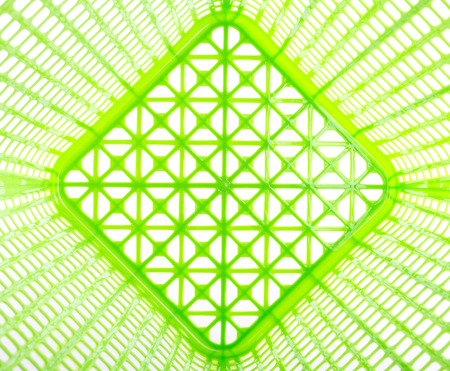 Texture inside of empty green plastic basket isolated on white backgroundの写真素材