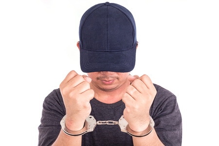 Close up man with handcuffs on hands isolated on white background