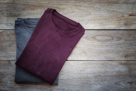 Top view of color T-Shirt on grey wood plank backgroundの写真素材