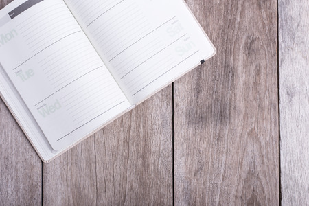 Top view of book on old wooden plank backgroundの写真素材