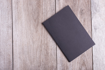 Top view of book on old wooden plank backgroundの写真素材