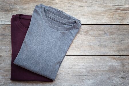 Top view of color T-Shirt on grey wood plank backgroundの写真素材