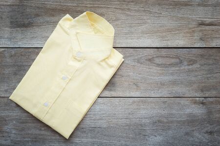Top view of color T-Shirt on grey wood plank backgroundの写真素材