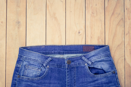 New blue jeans on wooden background top viewの写真素材