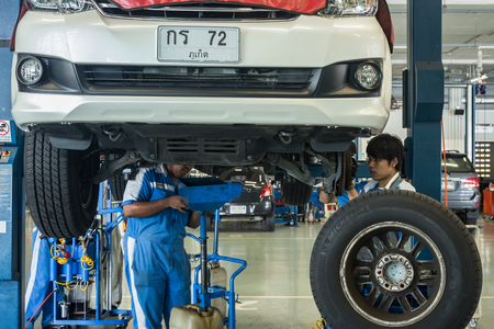 PHUKET, THAILAND - APRIL 22 : Car technician repairing car in workshop service station in Phuket on April 22, 2016. The official dealer of Toyota, who is the top market share for commercial car.のeditorial素材
