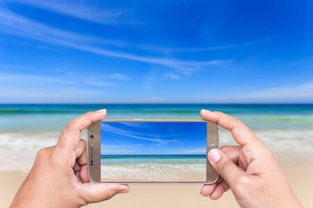 Close up hand of woman holding smartphone and take photo of view