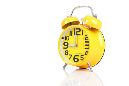 Close up yellow alarm clock isolated on white background