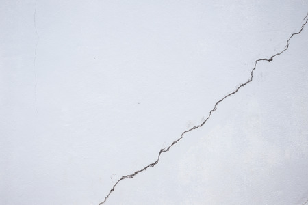 Close up cracked line on white building wallの写真素材