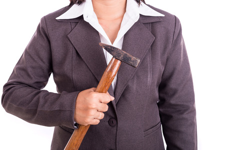 Close up Thai businesswoman holding hammer isolated on white backgroundの写真素材
