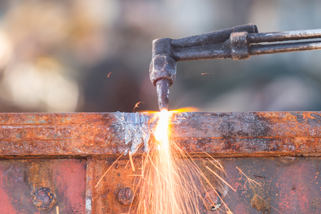 A worker cutting steel using metal torchの写真素材