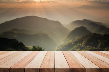 Empty top of wooden table or counter and view of landscape background. For product displayの写真素材
