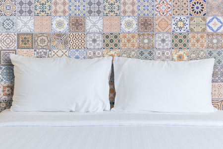 Close up white bedding sheets and pillow in hotel room