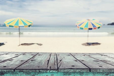 Empty top of wooden table and view of tropical beach background. For product displayの写真素材