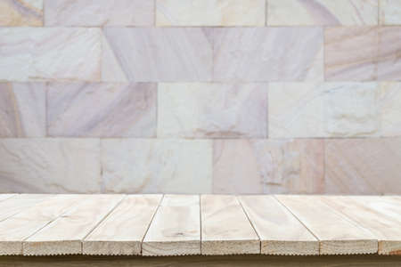 Empty top wooden table and natural stone wall background. For product displayの写真素材
